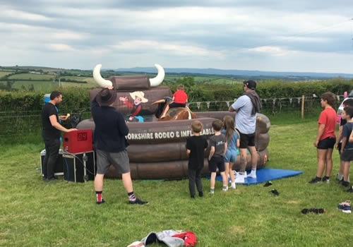 Families enjoying the Rodeo Rider in Town Farm Field 3/6/22 Photo Gallery Image - Families enjoying the Rodeo Rider in Town Farm Field 3/6/22
